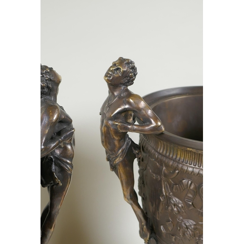 107 - A pair of Grand Tour style bronze urns on red marbled bases, with male figural twin handles, 41cm hi... 