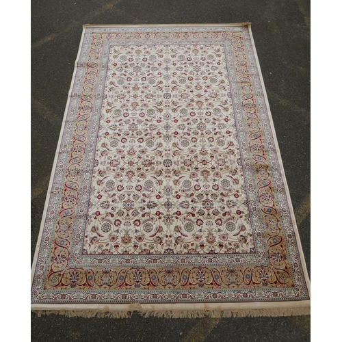 1072 - An ivory ground full pile Kashmir carpet with allover floral design and gold borders, 200 x 300cm