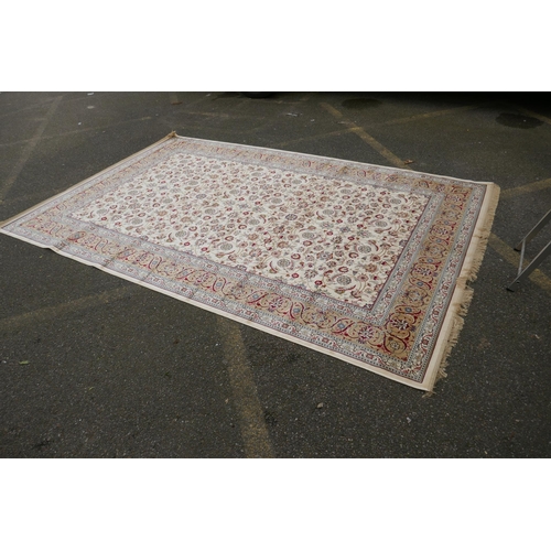 1072 - An ivory ground full pile Kashmir carpet with allover floral design and gold borders, 200 x 300cm