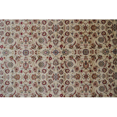 1072 - An ivory ground full pile Kashmir carpet with allover floral design and gold borders, 200 x 300cm