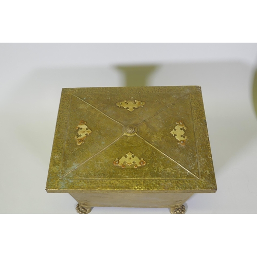 1076 - An Arts & Crafts brass sarcophagus shaped coal box raised on paw feet, 49 x 39cm