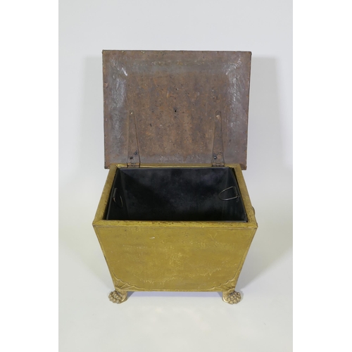 1076 - An Arts & Crafts brass sarcophagus shaped coal box raised on paw feet, 49 x 39cm