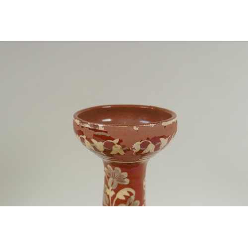 108 - An antique Islamic redware vase decorated with flowers and rodents, chips to glaze, 27cm high