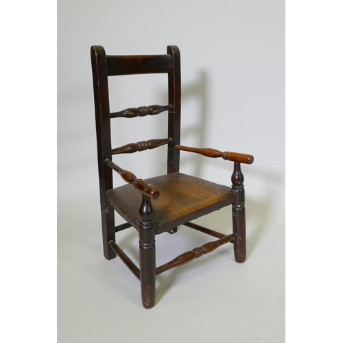 1080 - A C19th child's elm spindle back open armchair, 68cm high