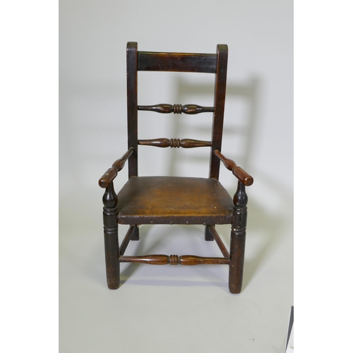 1080 - A C19th child's elm spindle back open armchair, 68cm high