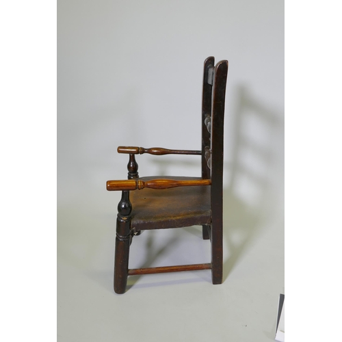 1080 - A C19th child's elm spindle back open armchair, 68cm high