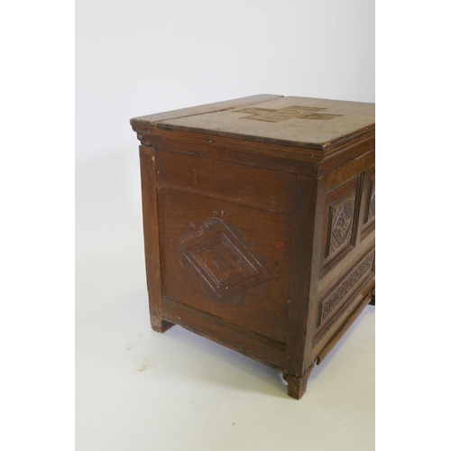 1083 - A C17th oak spice chest/coffer with carved panels, the cover dated 1691 and initialled MW, rear foot... 