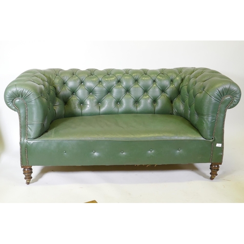 1089 - A Victorian button back leather Chesterfield settee, raised on turned supports, 165cm wide