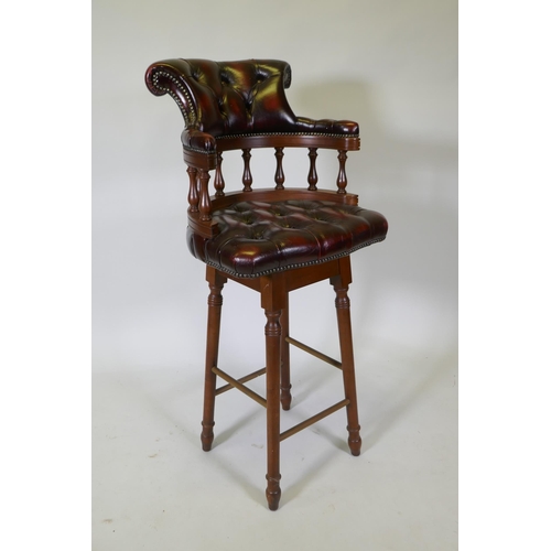 1090 - A captain's style buttoned oxblood leather stool, 118cm high