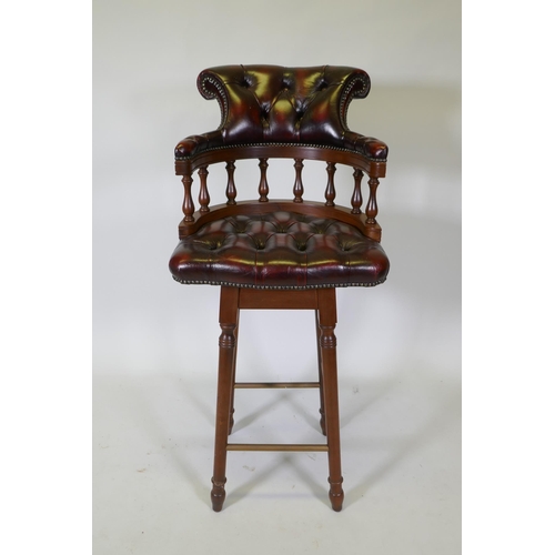 1090 - A captain's style buttoned oxblood leather stool, 118cm high