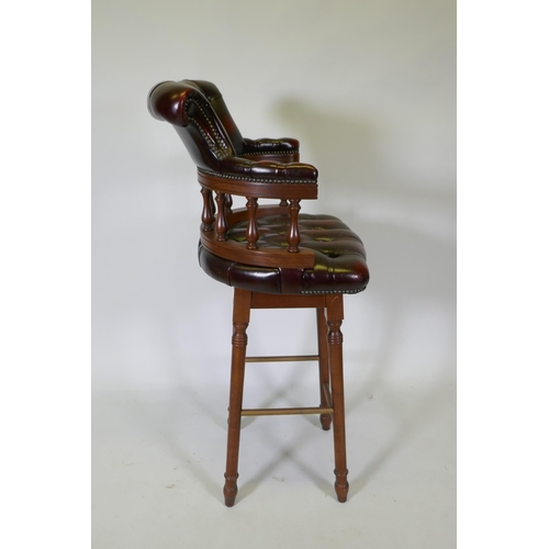 1090 - A captain's style buttoned oxblood leather stool, 118cm high