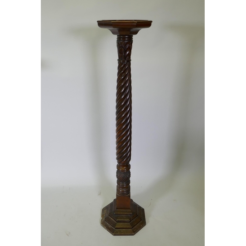 1092 - An antique carved hardwood torchere on a spiral column, 130cm high