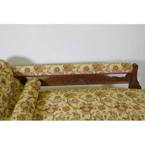 1093 - A Victorian walnut chaise longue with carved Grecian style decoration and good upholstery, 180cm lon... 