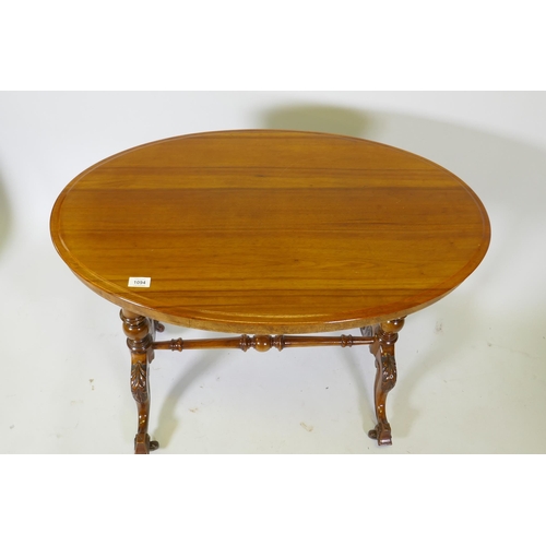 1094 - A Victorian walnut stretcher table, oval top raised on turned end columns with carved cabriole suppo... 