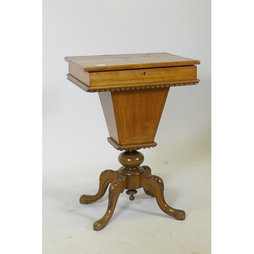 1100 - A Victorian inlaid walnut workbox, the rising top revealing a fitted interior, raised on carved cabr... 