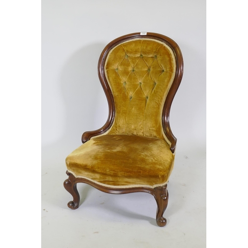 1103 - A Victorian mahogany nursing chair with button back and cabriole supports