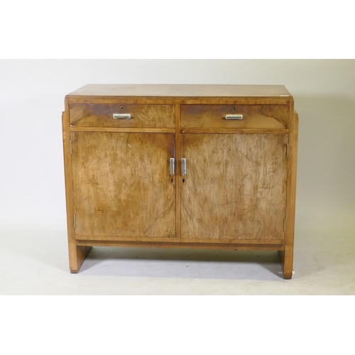 1111 - An Art Deco walnut odeon style buffet/sideboard, two drawers over cupboards and original chromed han... 