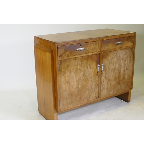 1111 - An Art Deco walnut odeon style buffet/sideboard, two drawers over cupboards and original chromed han... 