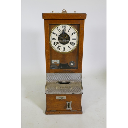 112 - An oak cased National Time Recorder Co clocking-in machine, 34 x 28cm, 88cm high