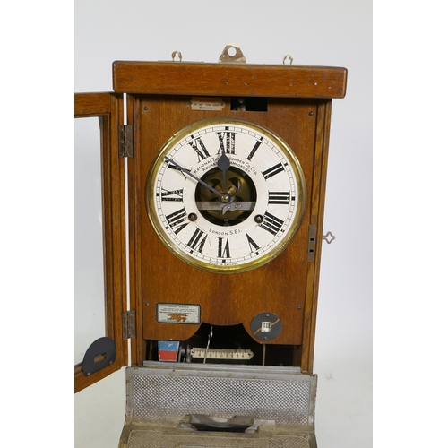 112 - An oak cased National Time Recorder Co clocking-in machine, 34 x 28cm, 88cm high