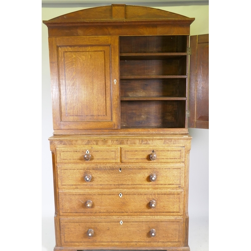 1121 - An early C19th oak linen press/housekeeper's cupboard, the upper section with two doors, fitted with... 