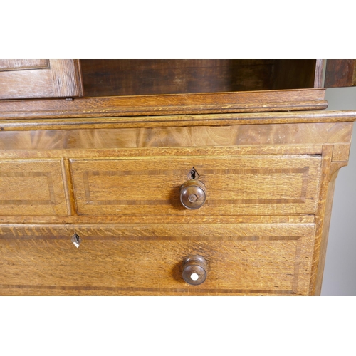 1121 - An early C19th oak linen press/housekeeper's cupboard, the upper section with two doors, fitted with... 