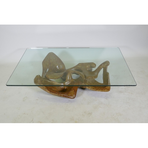 1122 - A contemporary coffee table with glass top and reconstituted stone base, 80 x 130cm