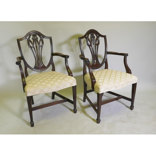 1123 - A pair of Hepplewhite style shield back mahogany elbow chairs, late C19th/early C20th