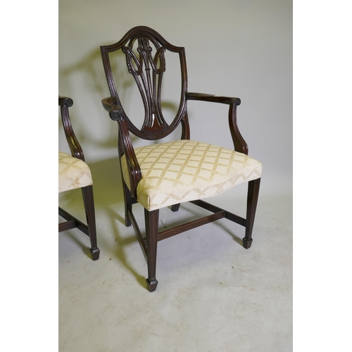 1123 - A pair of Hepplewhite style shield back mahogany elbow chairs, late C19th/early C20th