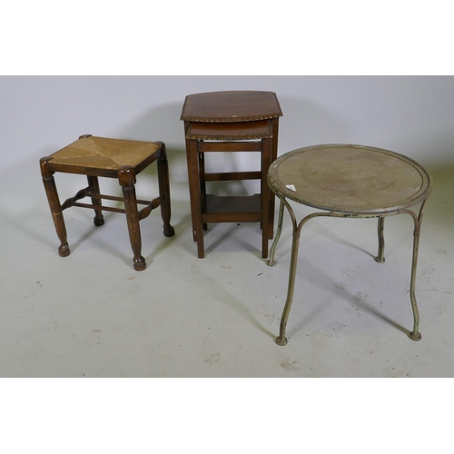 1128 - A painted metal occasional table, 45cm diameter x 45cm high, a rush seated stool and nest of two tab... 