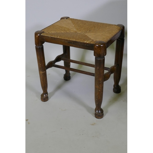 1128 - A painted metal occasional table, 45cm diameter x 45cm high, a rush seated stool and nest of two tab... 