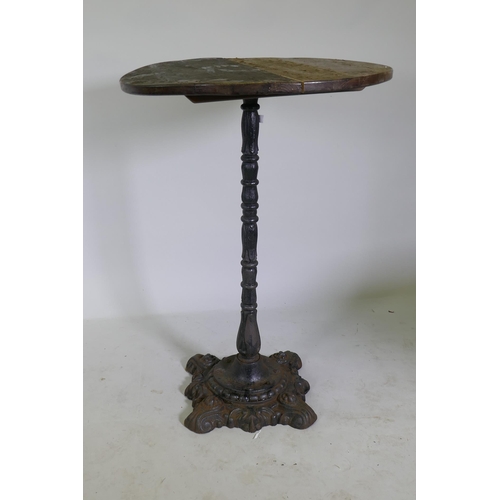 1129 - An antique cast iron pub table with wood top, 72cm diameter, 102cm high