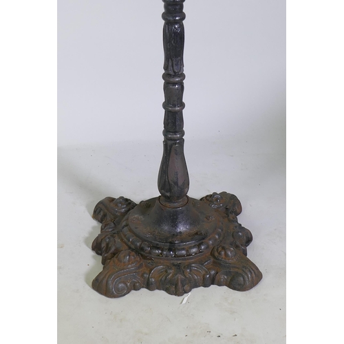 1129 - An antique cast iron pub table with wood top, 72cm diameter, 102cm high