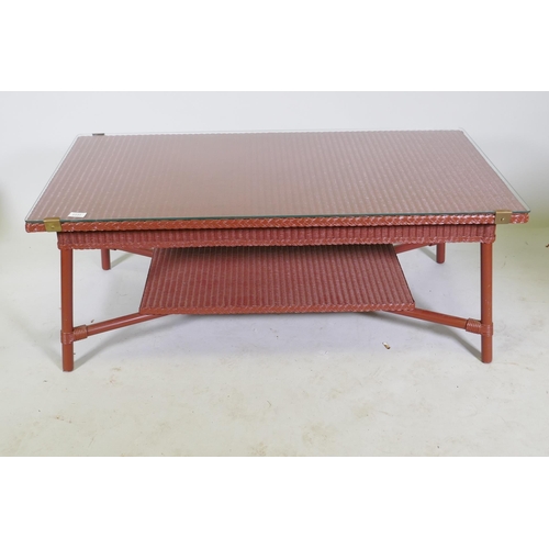 1131 - A Lloyd Loom coffee table with glass top and undertier, 60 x 120 x 47cm