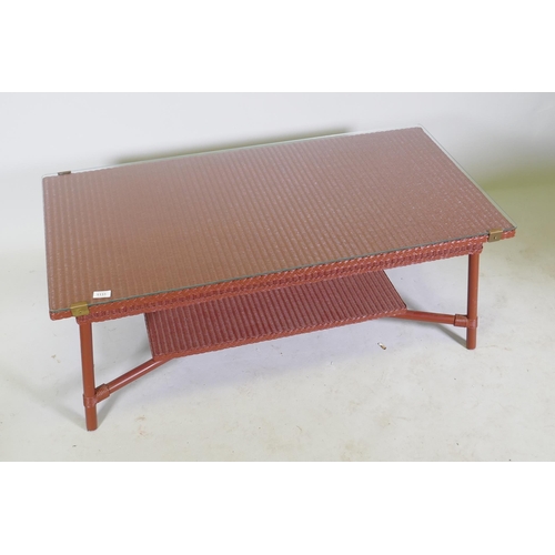 1131 - A Lloyd Loom coffee table with glass top and undertier, 60 x 120 x 47cm