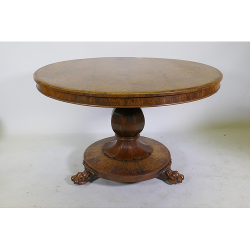 1134 - A C19th rosewood tilt top breakfast table, raised on a shaped column with carved detail and platform... 