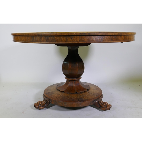 1134 - A C19th rosewood tilt top breakfast table, raised on a shaped column with carved detail and platform... 