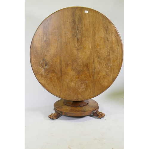 1134 - A C19th rosewood tilt top breakfast table, raised on a shaped column with carved detail and platform... 