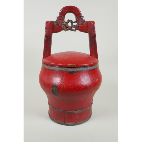 116 - A Chinese red lacquered wood food carrier, 36cm high