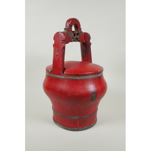 116 - A Chinese red lacquered wood food carrier, 36cm high