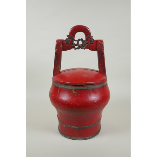 116 - A Chinese red lacquered wood food carrier, 36cm high