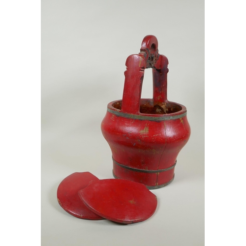 116 - A Chinese red lacquered wood food carrier, 36cm high