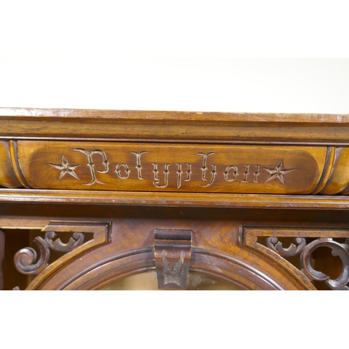 1175 - A walnut polyphon case, with pierced spandrels and arched glazed door with apple columns, 62 x 36 x ... 