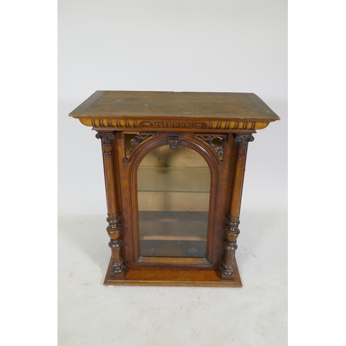 1175 - A walnut polyphon case, with pierced spandrels and arched glazed door with apple columns, 62 x 36 x ... 