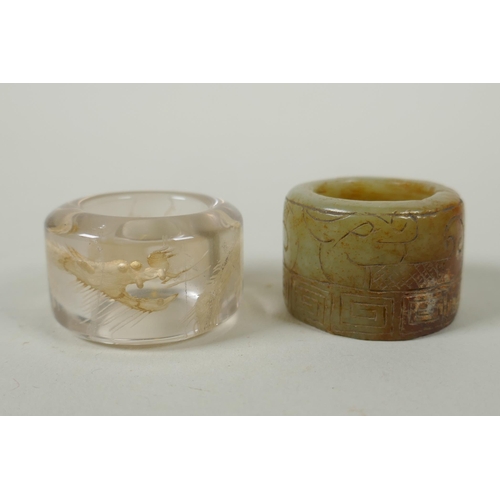 118 - A Chinese crystal archers thumb ring, with engraved dragon decoration, and a nephrite jade thumb rin... 