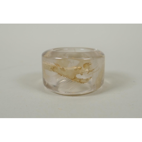 118 - A Chinese crystal archers thumb ring, with engraved dragon decoration, and a nephrite jade thumb rin... 