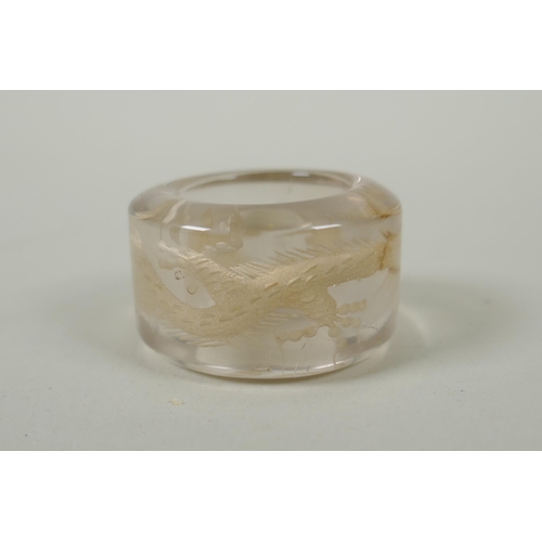 118 - A Chinese crystal archers thumb ring, with engraved dragon decoration, and a nephrite jade thumb rin... 