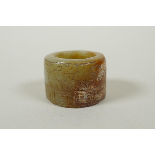 118 - A Chinese crystal archers thumb ring, with engraved dragon decoration, and a nephrite jade thumb rin... 