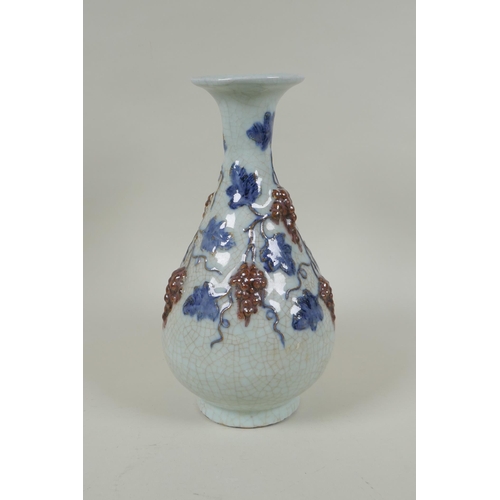 119 - A Chinese crackleware pear shaped vase with raised blue and red grape vine decoration, 25cm high