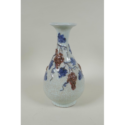 119 - A Chinese crackleware pear shaped vase with raised blue and red grape vine decoration, 25cm high